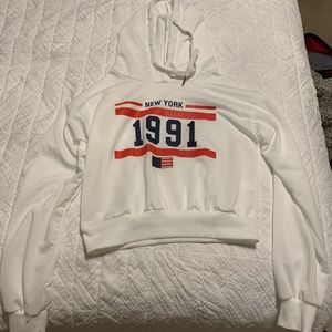 A white New York crop top from the website Shein